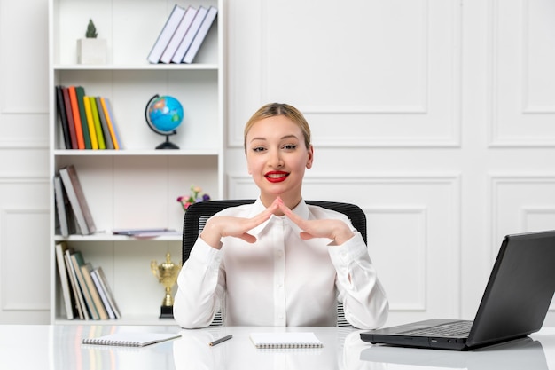 Customer service cute girl in white shirt with red lipstick and laptop smiling and holding hands