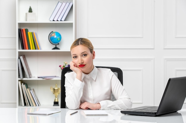 Customer service cute girl in white shirt with red lipstick and laptop thinking and tired