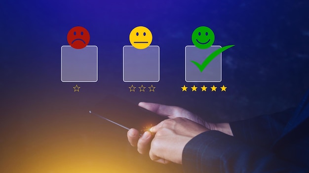 Customer service evaluation concept feedback rating and positive customer review experience using a smartphone And pressing face emoticon smile in satisfaction on virtual touch screen