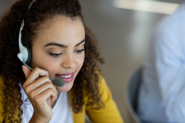 Customer service executive talking on headset in office