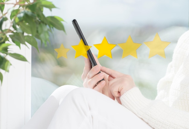 Customer service experience and business satisfaction survey Woman hand using smart phone with icon five star symbol to increase rating of company concept