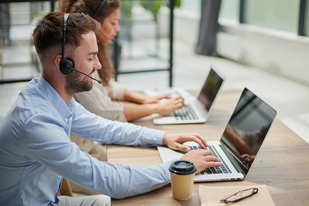 Customer service representative with colleague working in office