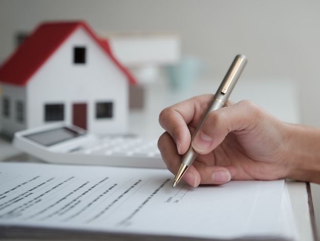 Customers are reading loan and insurance agreement documents to sign real estate transactions