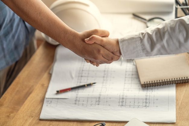 Customers handshake agreement with the contractor for construction of houses