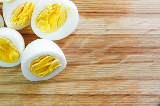 cut boiled eggs on a wooden board in the kitchen