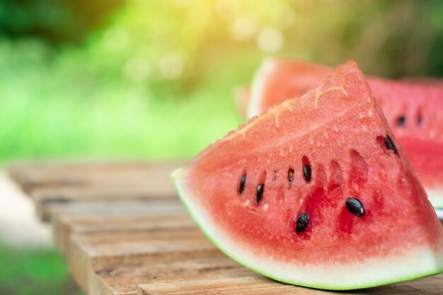 Cut fresh juicy watermelon on a wooden brown desk or table