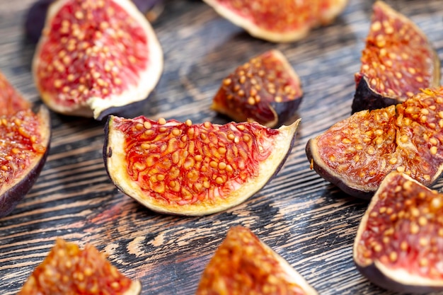 Cut into half ripe red fresh figs with seeds sweet halves of red figs during cooking