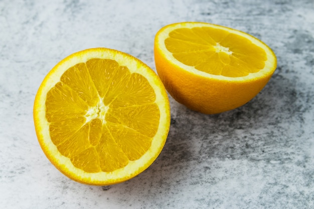 Cut oranges on a concrete light table