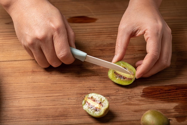 Cut ripe kiwi fruit on a wooden table