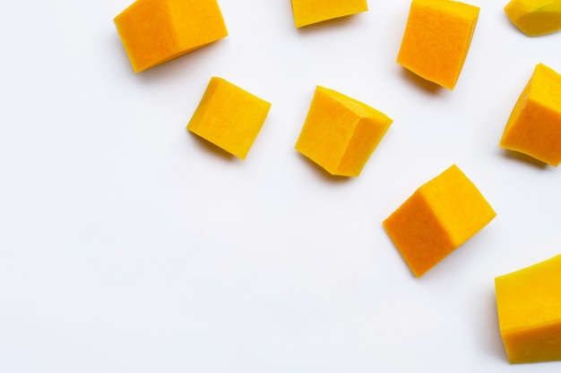 Cut and slices butternut squash on white background.