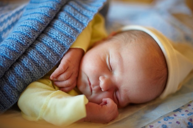 Cute 3 days newborn baby sleeps at home