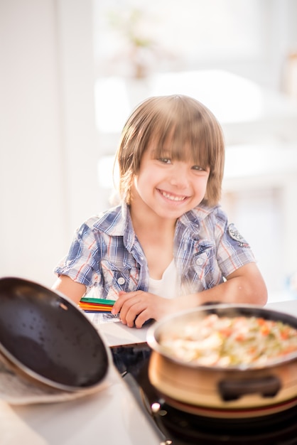 Cute adorable little boy in the kitchen