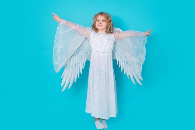 Cute angel kid studio portrait blonde curly little angel child with angels wings isolated background