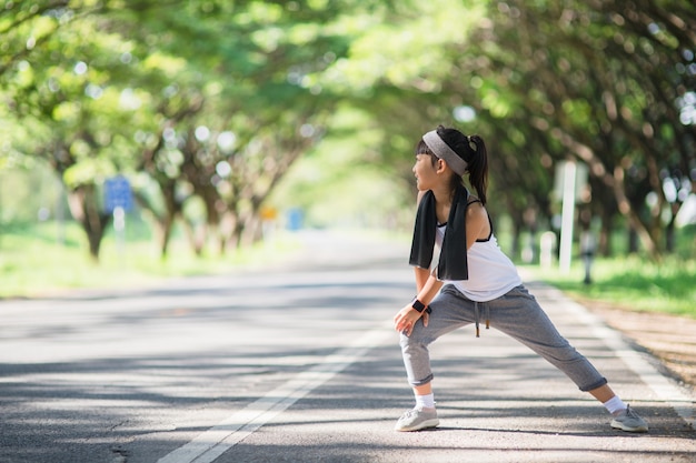 Cute asian girl exercise in gardent background