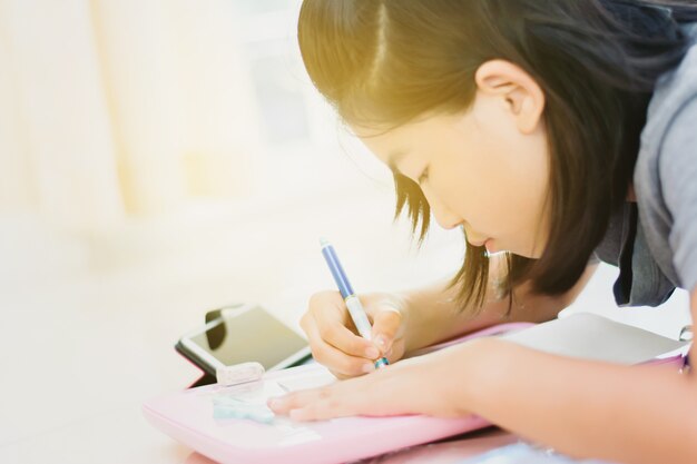 Cute Asian kids drawing cartoon at home in morning