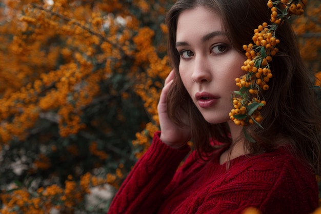 Cute asian woman in a good mood poses in autumn day, enjoying the good weather. The art of the work of a romantic woman