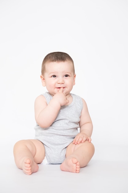 Cute baby boy sit or crowl closeup portrait of adorable child isolated on white background sweet toddler healthy childhood perfect caucasian infant lovely kid innocence concept