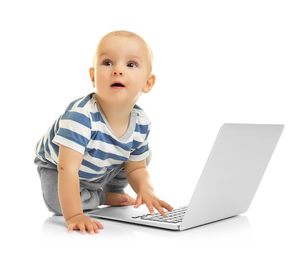 Cute baby boy with laptop on white background