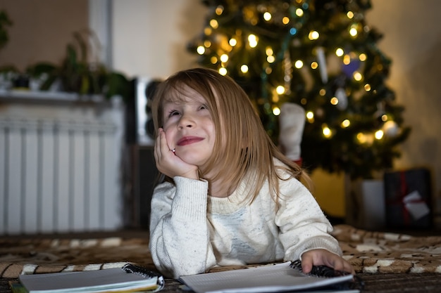 Cute baby girl write a letter to Santa