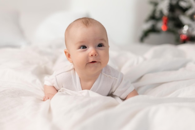 Cute baby at home in bed for Christmas The first New Year Christmas Gift