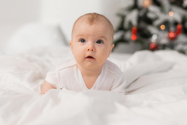 Cute baby at home in bed for Christmas The first New Year Christmas Gift