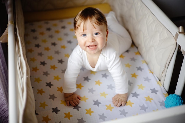 a cute baby is smiling while sitting in bed