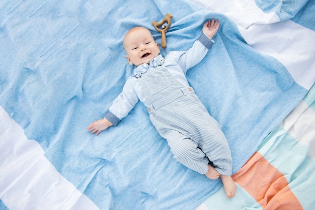 Cute baby lying on blue background