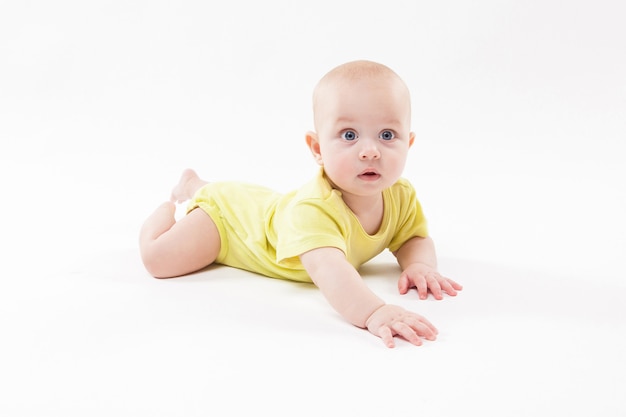 Cute baby lying on the ground and smiling