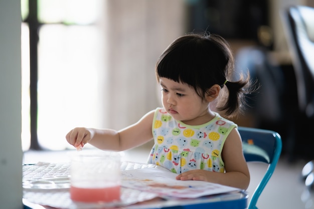 Cute baby painting plaster puppet on the table, art concept