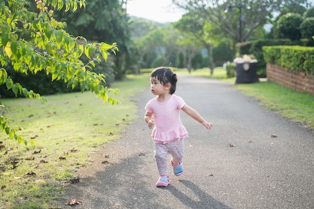 Cute baby running in a garden