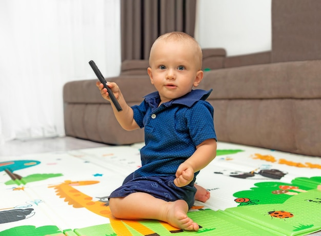 Cute baby sits on couch at home