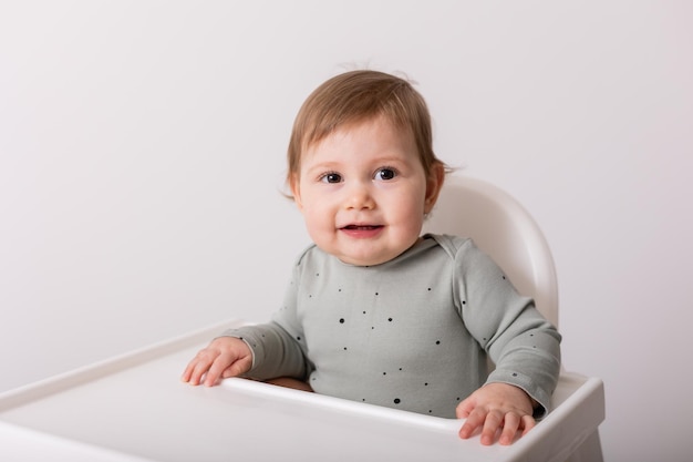 Cute baby sitting in high chair card banner space for text