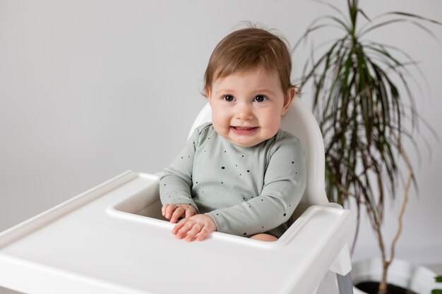 cute baby sitting in high chair card banner space for text