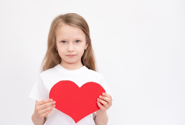 Cute Beautiful Sixyear Girl Hold Big Red Heart Looking Reflectively Away From Camera Close Up peace in world