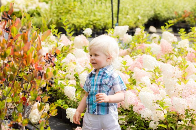 Cute blonde boy outdoor at botanical garden