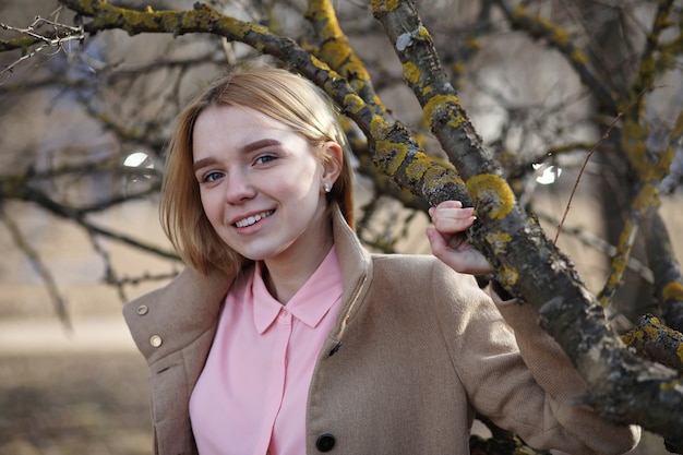 Cute blonde in a city park on a cold sunny day