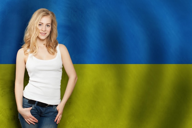 Cute blonde smiling woman with and Ukrainian flag Tourist and education concept