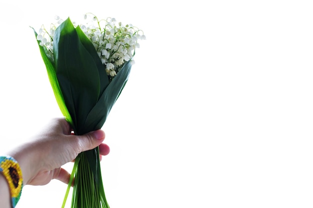 Cute bouquet of lilies of the valley on a white background