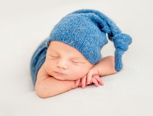 Cute boy in blue bonnet sleeping