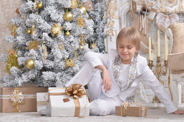 Cute boy posing  near Christmas tree