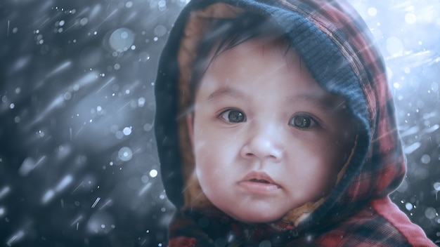 Cute boy with winter snow