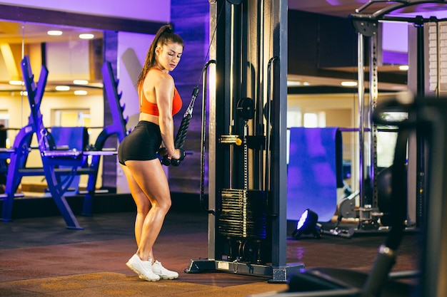 Cute brunette working out at a gym