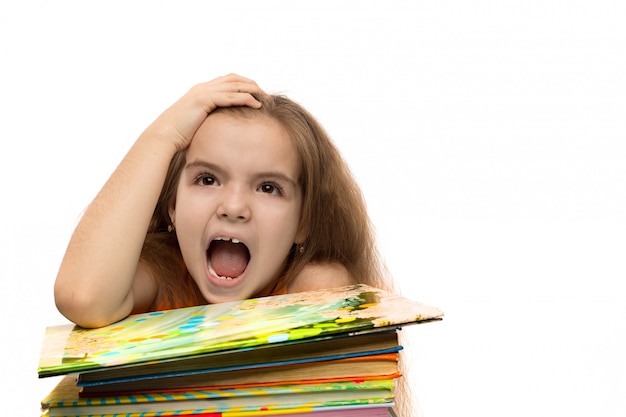 Cute caucasian little girl with books. School portrait. Isolated on white background