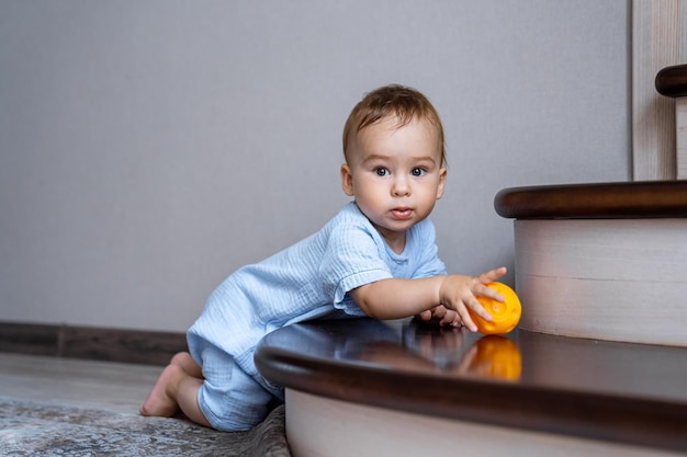 Cute cheerful baby playing with colorful toy at home Early development concept