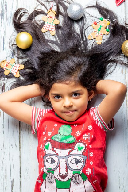 Cute cheerful smiling girl with decorated Christmas hair