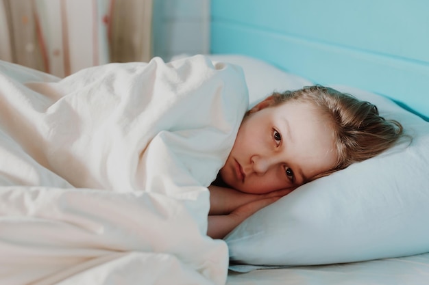 Cute child little girl sleeps in the bed