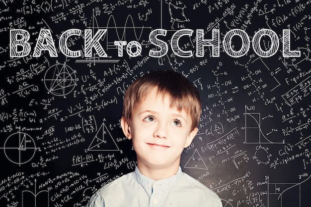 Cute Child School Boy on Blackboard Background