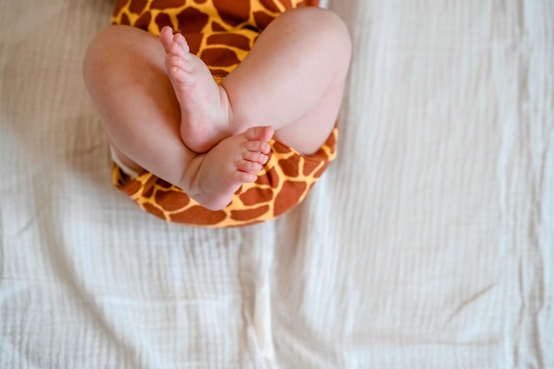 Cute chubby baby legs on a white sheet