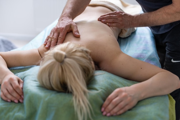 Cute chubby woman getting a back massage at home.