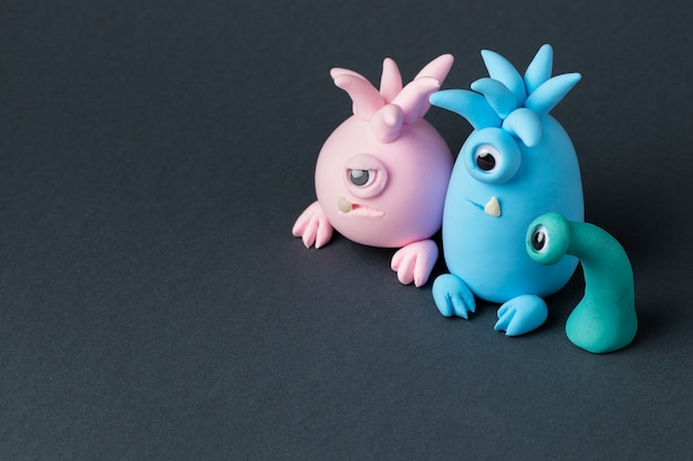 Cute colorful play dough monsters high angle